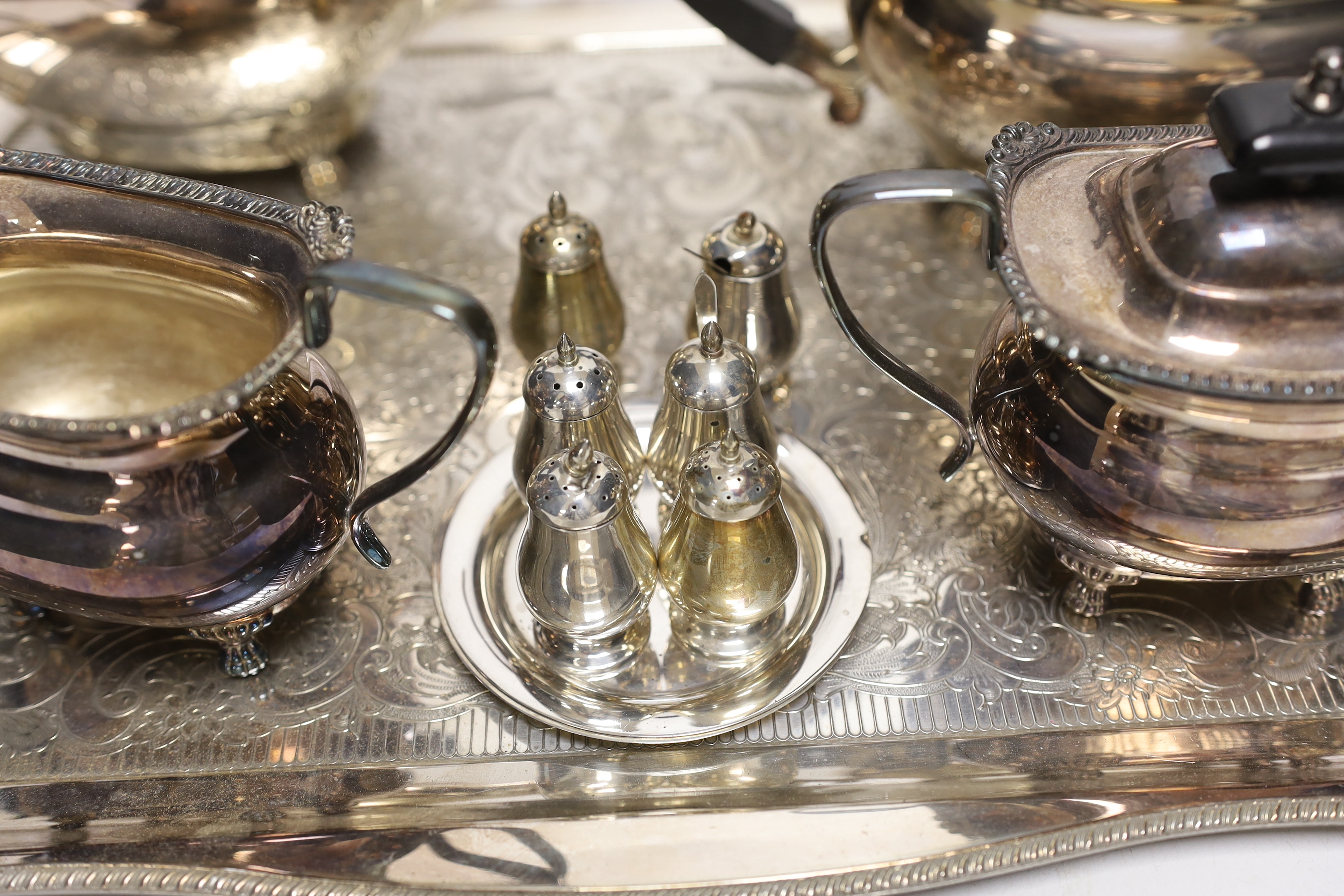 A plated tea / coffee set with ebonised handles and two Sterling condiment sets